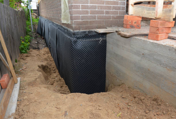 SJ Waterproofing Pros technician performing targeted Wet Basement Repair assessment in Miamisburg, OH